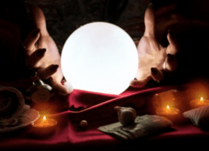 A crystal ball and a fortune teller hands represent Irish halloween traditions.
