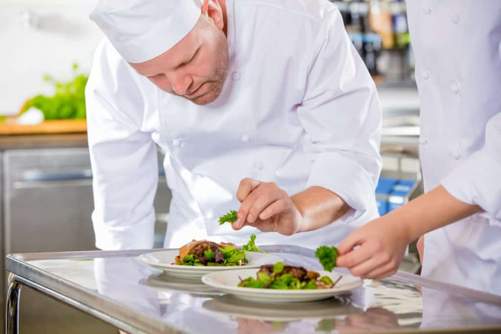 Chefs preparing food behind the scenes
