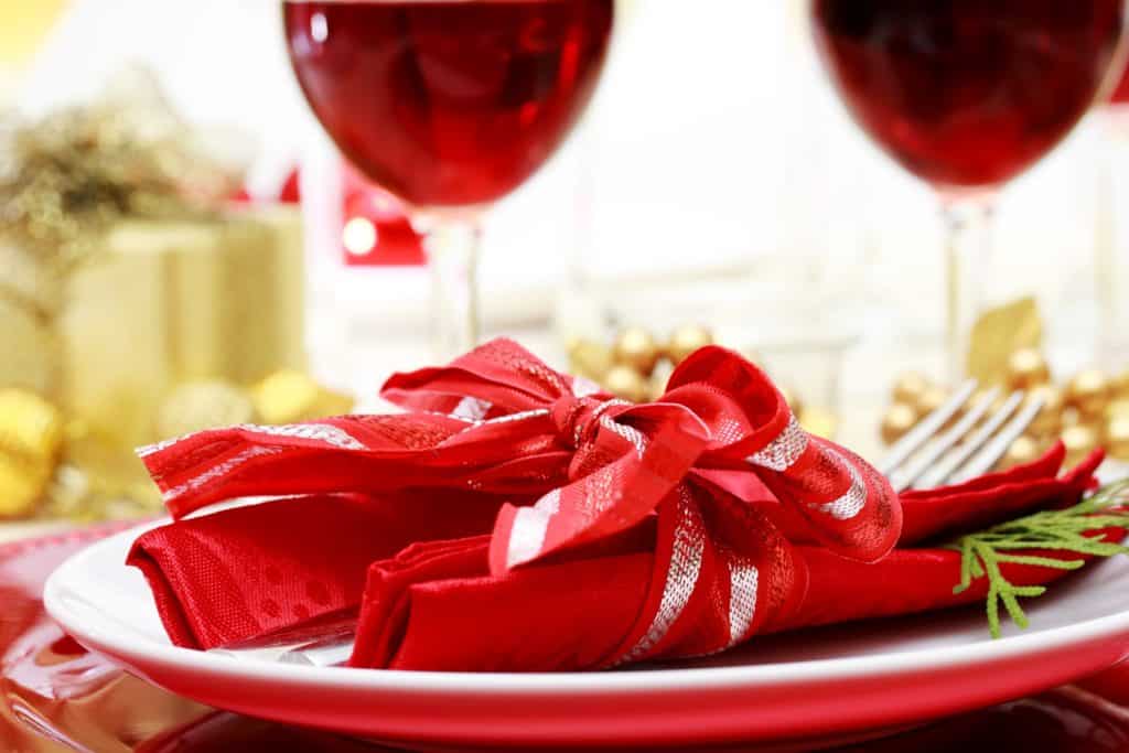 Red table setting with silverware and glasses