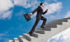 Travel and Tourism Degree Top 4 interesting Career Options!(Man-in-Suit-Climbing-a-staircase-in-the-Sky)