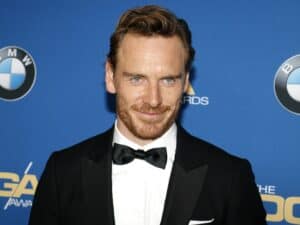 Michael Fassbender min Michael Fassbender is an Irish German actor, born on the 2nd of April 1977. He was born in Heidelberg, Germany to a German father, Josef, and an Irish mother, Adele who is originally from Larne, County Antrim, in Northern Ireland. His mother is also the great-grand-niece of Irish revolutionary, soldier, and politician Michael Collins. Fassbender was raised in the town of Killarney, Ireland. His family moved there since he was two years old, and his father was a chef so he ran a restaurant called West End House. He studied at the Fossa National School and after that at the St. Brendan's College.