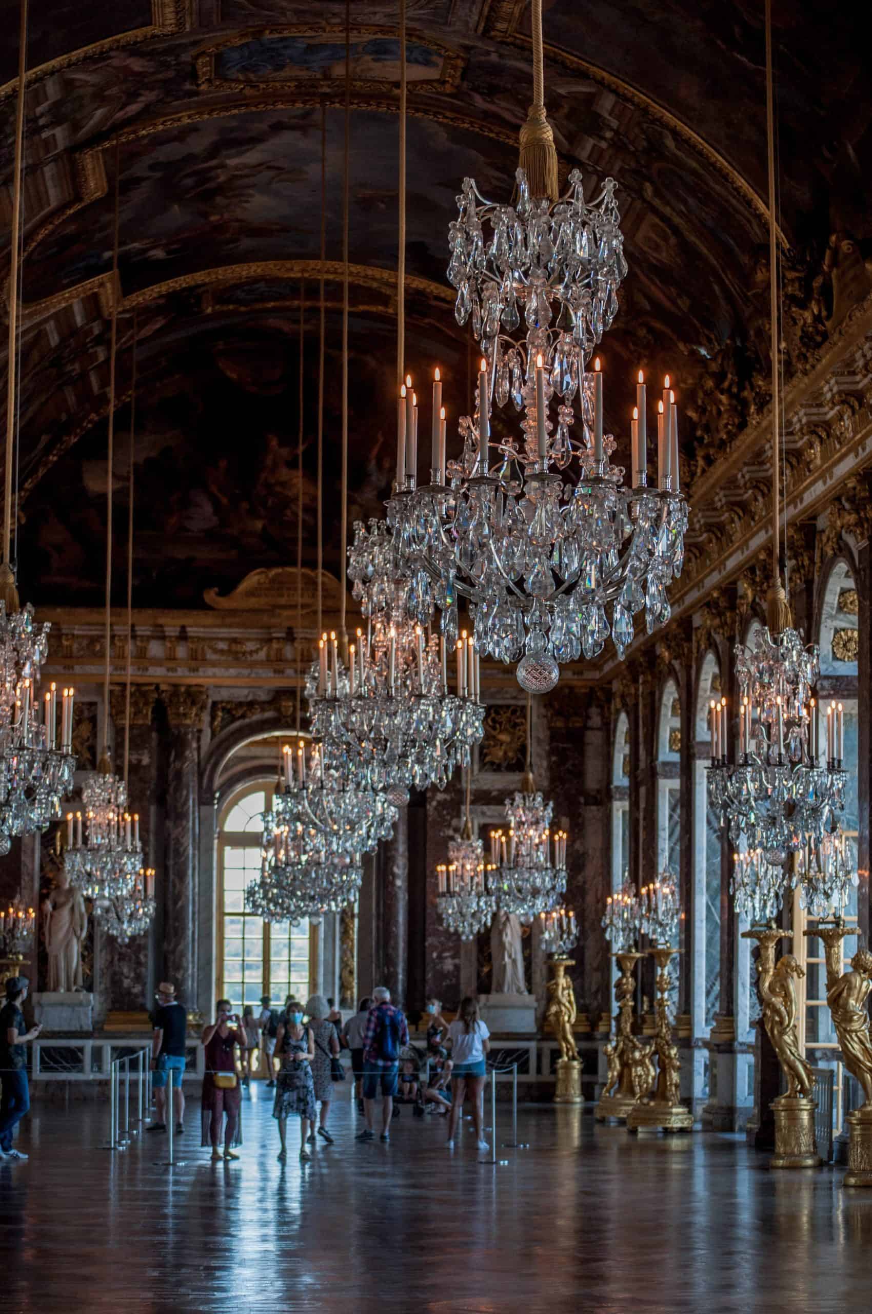 Tourists roam the Hall of Mirrors at the Palace of Versailles in France