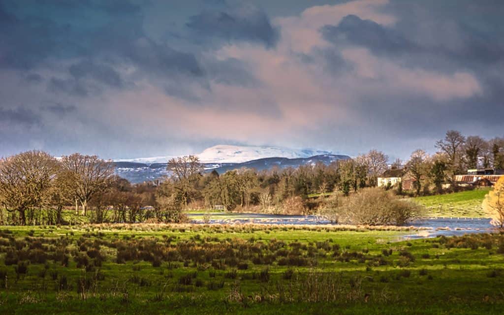 The snow-capped Cuilcagh Mountains seen from Belle Isle Estate in County Fermanagh
