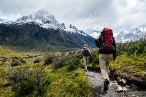 Two people hiking in single file