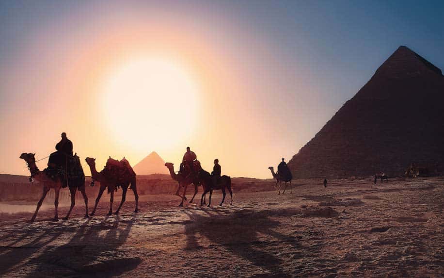 Summer destinations in Egypt camels in front of pyramids