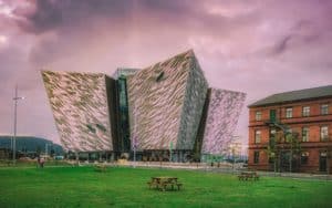 The gorgeous titanic museum illuminated by the pink sky in Belfast