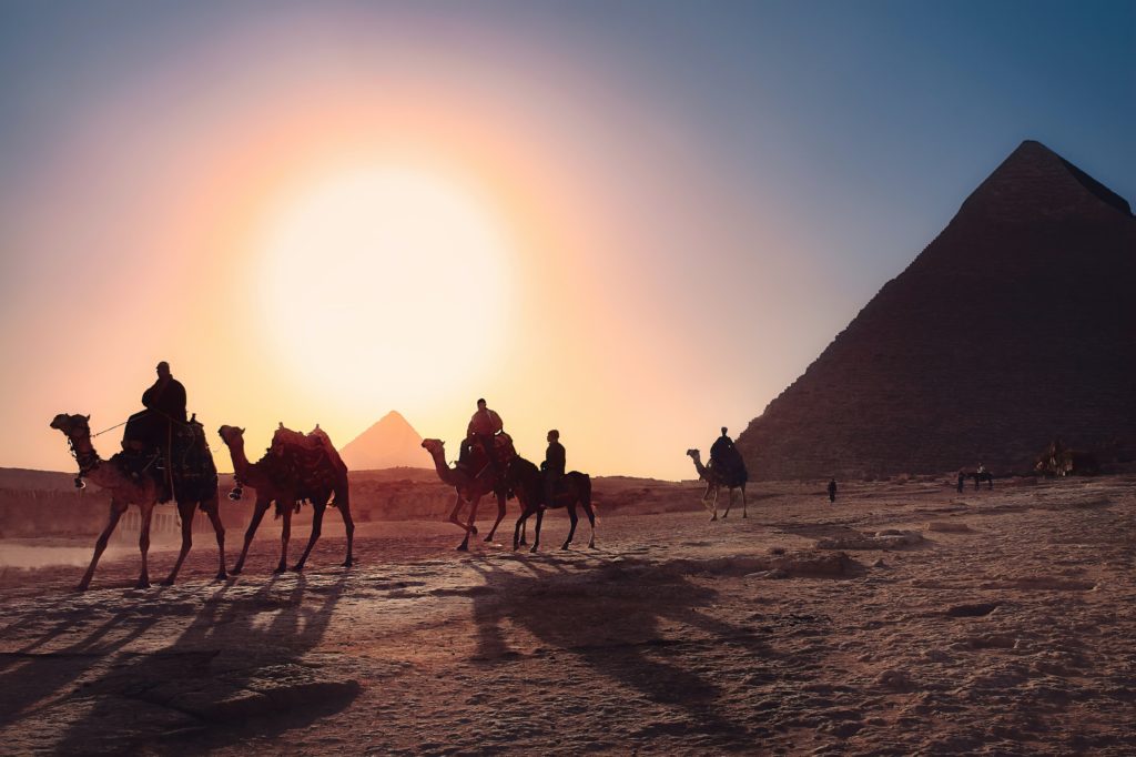 Taking a camel ride while visiting the Pyramids
