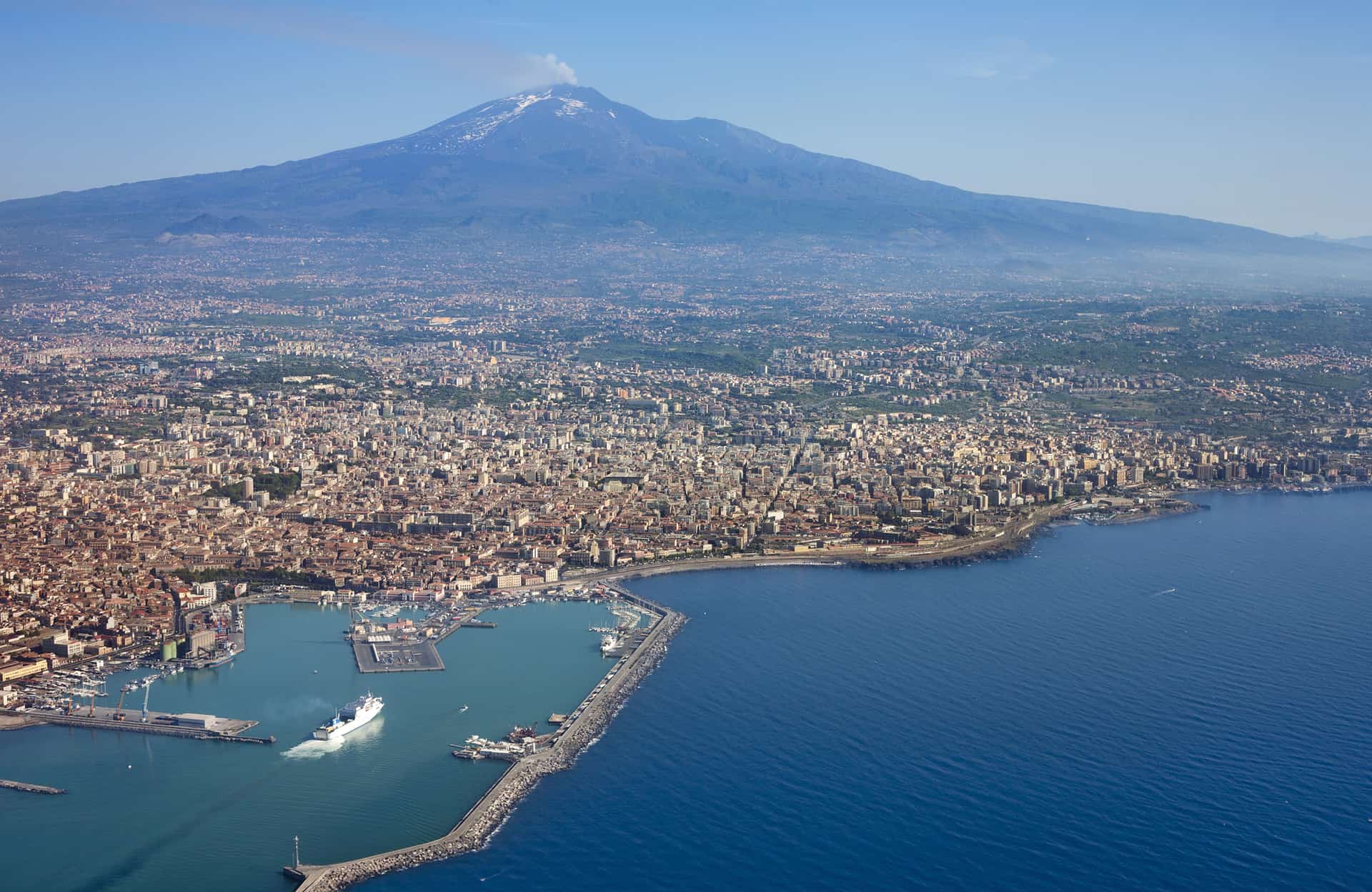 Air photo of Catania city in Sicily with the Etna Volcano in the back.