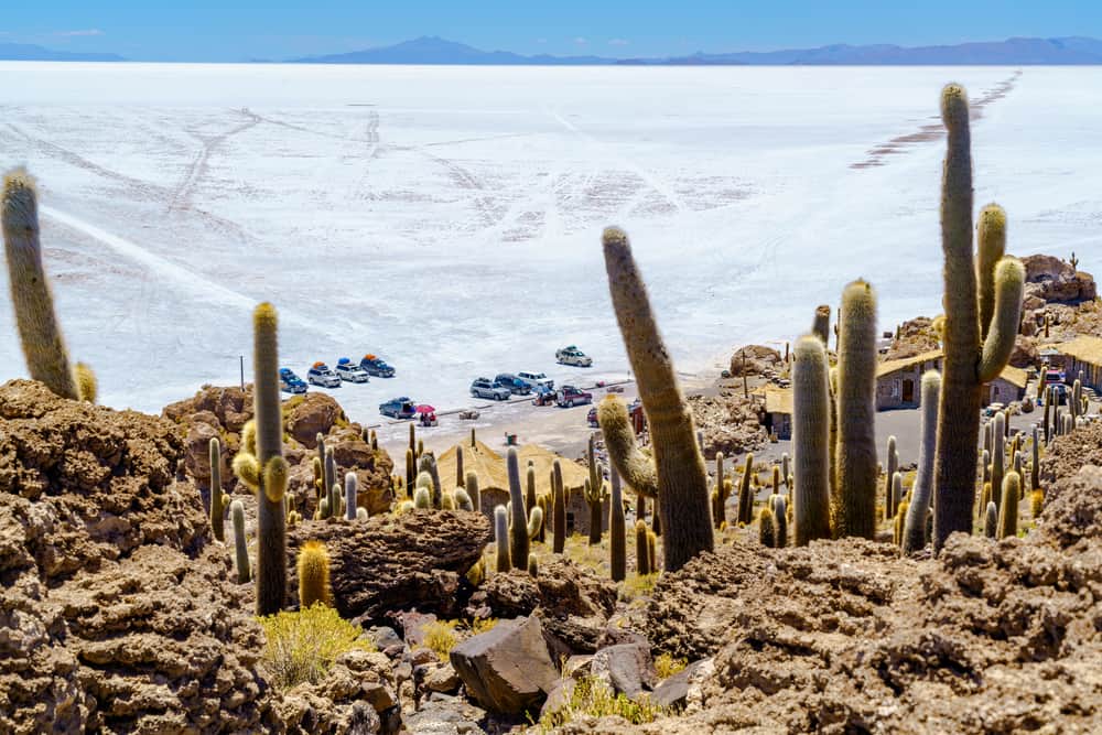 Tourists parking car at Incahuasi Island in Salar de Uyuni Salt Flat for sightseeing and having lunch