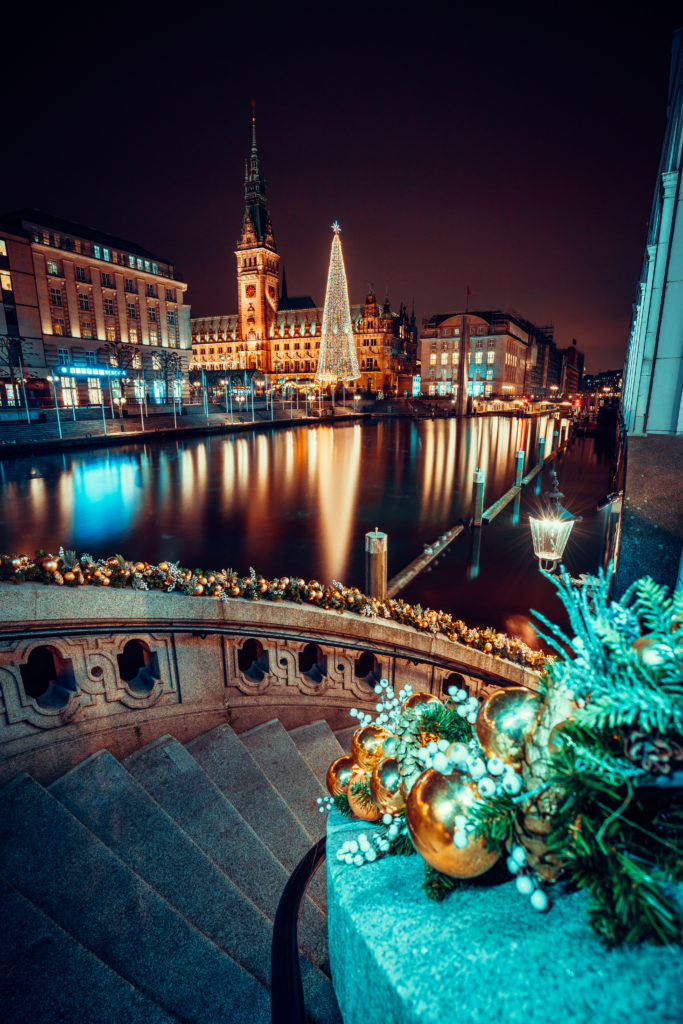Christmas time at Alsterfleet and the City hall in Hamburg at night. Beautiful illuminated downtown, city center.