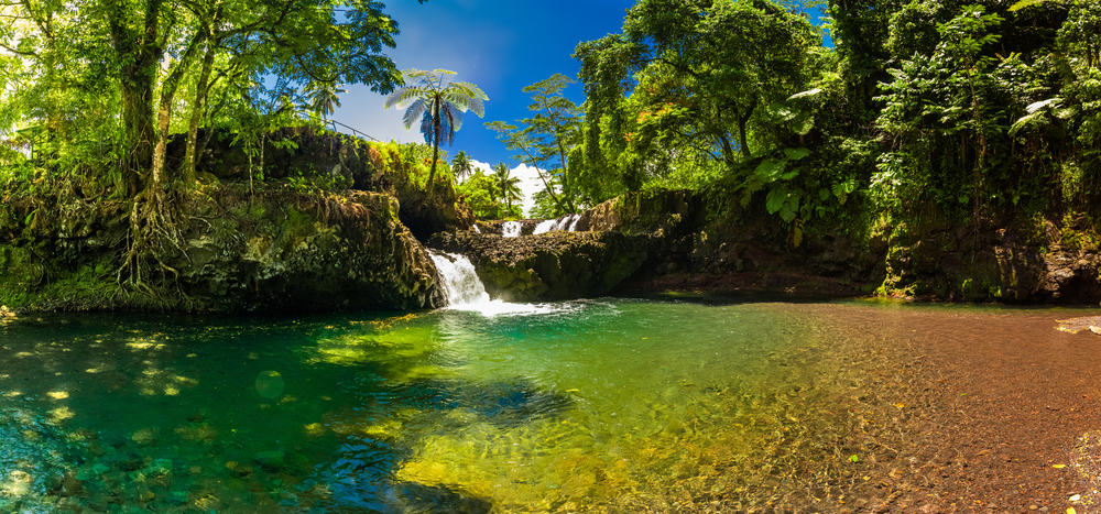 Vibrant Togitogiga falls with swimming hole on Upolu, Samoa