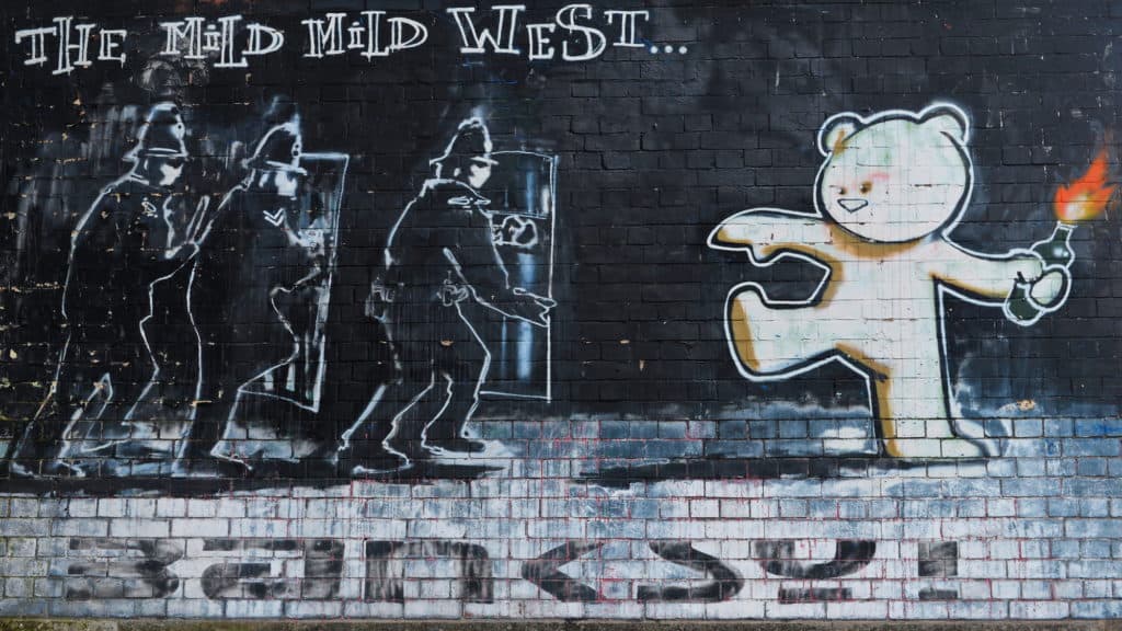 View of the famous Banksy graffiti piece titled Mild Mild West
