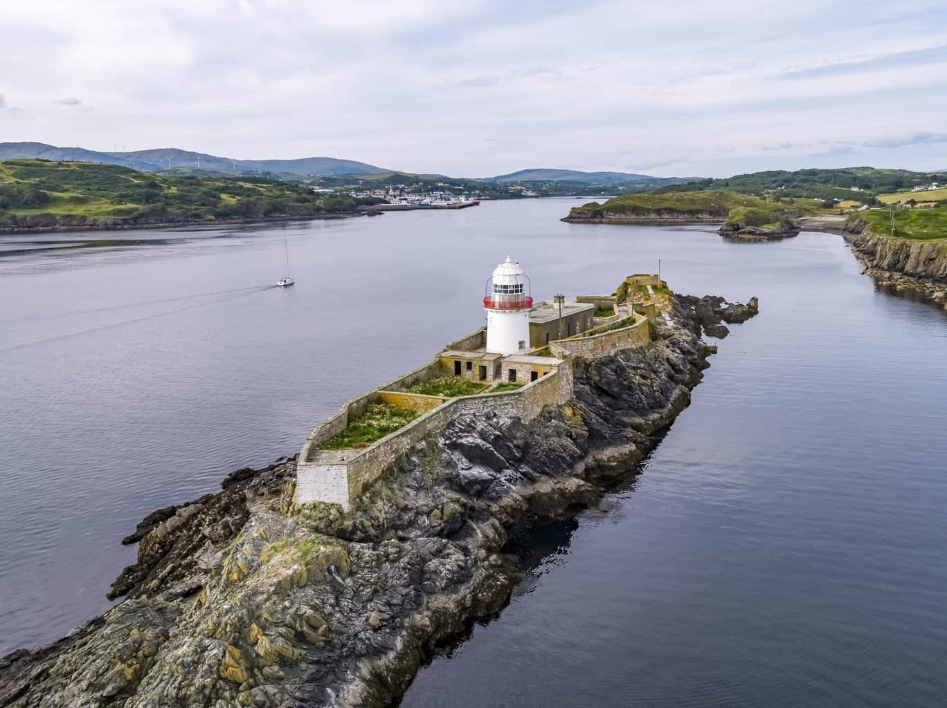 Aerial of the Rotten Island Lighthouse with Killybegs in background - County Donegal - Ireland.