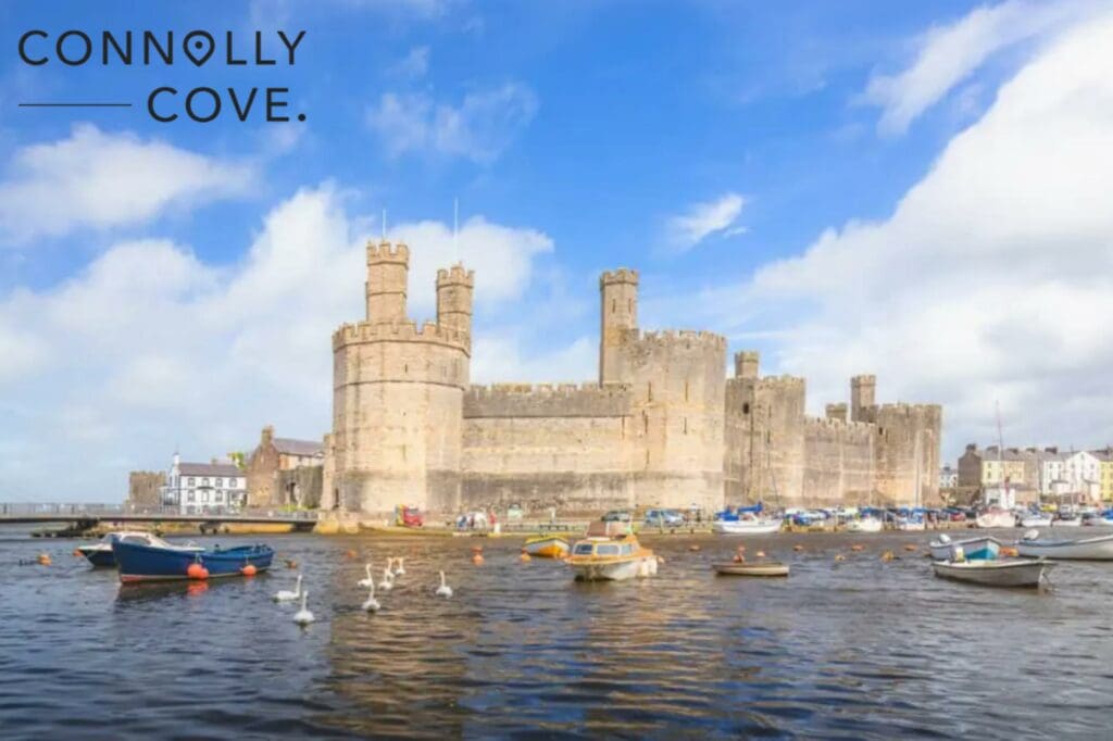 The historic medieval Caernarfon Castle on the River Seiont on a summer day in North Wales