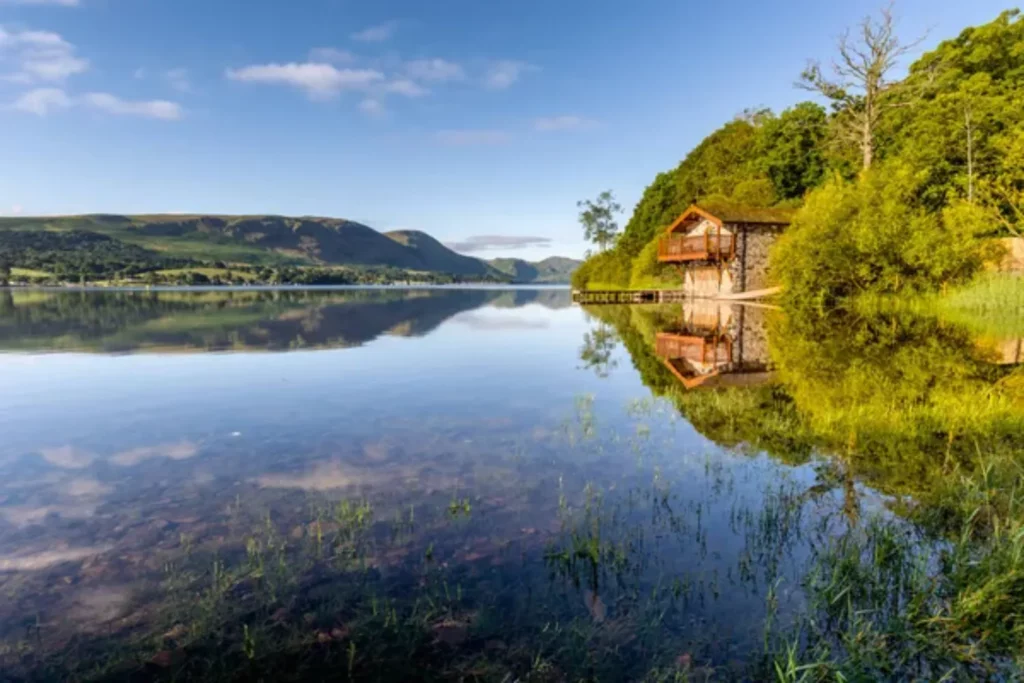 depositphotos 429687640 stock photo clear reflections boathouse mountains surrounding The United Kingdom is full of attractions, including castles, historical buildings, and incredible natural landscapes like parks and lakes. Today, we will talk about one of the famous natural landscapes in the United Kingdom, the Natural Lakes in the Lake District.