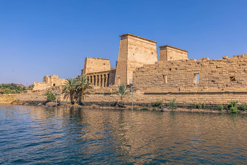 Philae 2 min The Temple of Philae, located on the serene Agilkia Island in Lake Nasser, Egypt, stands as a historical jewel beckoning exploration. This architectural marvel, originally located on Philae Island, was painstakingly relocated to preserve its splendour from the Aswan High Dam's rising waters.