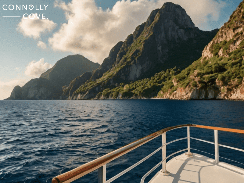 cruise lines ranked 

A boat approaches steep, green mountains rising from the ocean under partly cloudy skies. The image, featuring the "Connolly Cove" logo in the upper left corner, evokes popular destinations visited by top Cruise Lines Ranked like Royal Caribbean International.