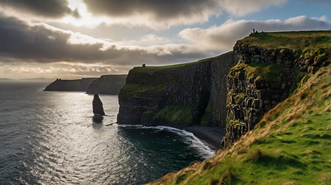 Ireland Holidays Steep grassy cliffs overlook the ocean near Dublin, with dark rocky outcrops and waves crashing below, under a cloudy sky with sunlight breaking through—perfect for memorable Irish holidays.