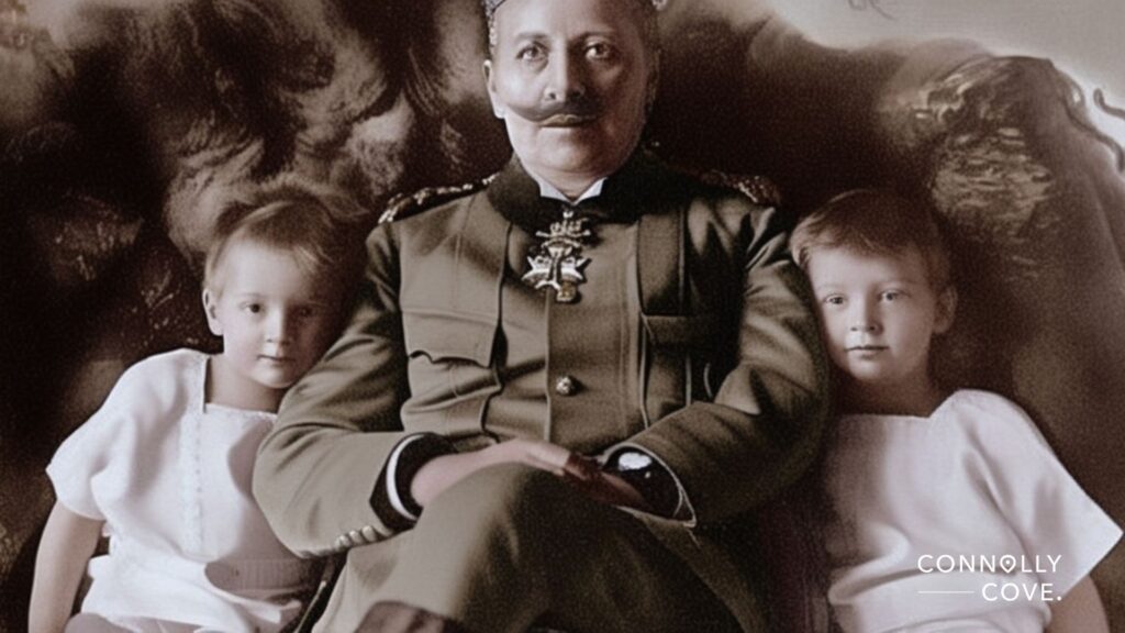 A historical photo shows a man in a military uniform, reminiscent of the Victoria era, sitting with two young children, one on each side. The man has a prominent mustache and medal; all three look toward the camera. "Connolly Cove" appears in the corner.