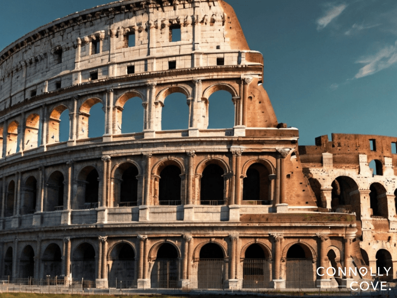 Rise and Fall of the Roman Republic
The ancient Roman Colosseum, a marvel from the days of the Roman Republic, is shown in sunlight against a blue sky. The iconic stone arches and partial ruins are visible. CONNOLLY COVE is written in white text in the lower right corner.