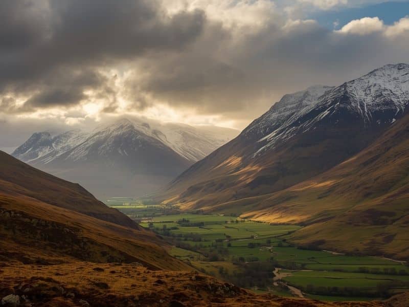 Snow-capped Highland mountains contrasting with green valleys in Scotland during March