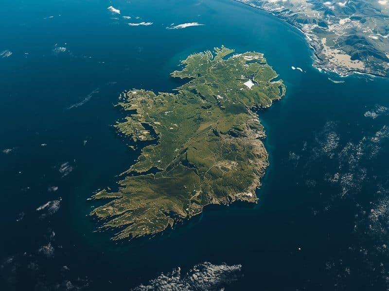 Aerial view of Ireland island surrounded by Atlantic Ocean and Irish Sea showing green landscape