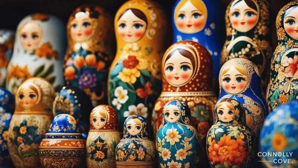 A collection of colourful Russian nesting dolls, decorated with floral patterns and displayed in rows. Showcasing traditional Russian folk art, the dolls vary in size and feature detailed, painted faces. CONNOLLY COVE is visible in the bottom right corner.