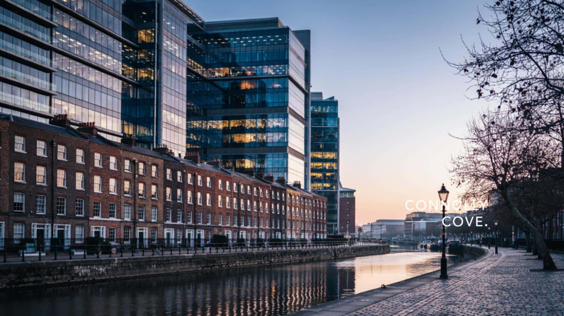 The Celtic Tiger: Dublin's modern Docklands skyline rising behind historic Georgian townhouses at dusk.
