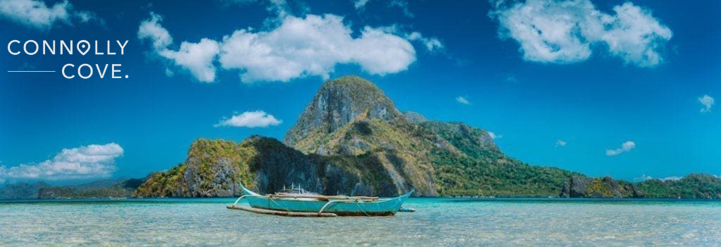 A fishermens boat in Blue Bay in front of Cadlao Island in Palawan Philippines