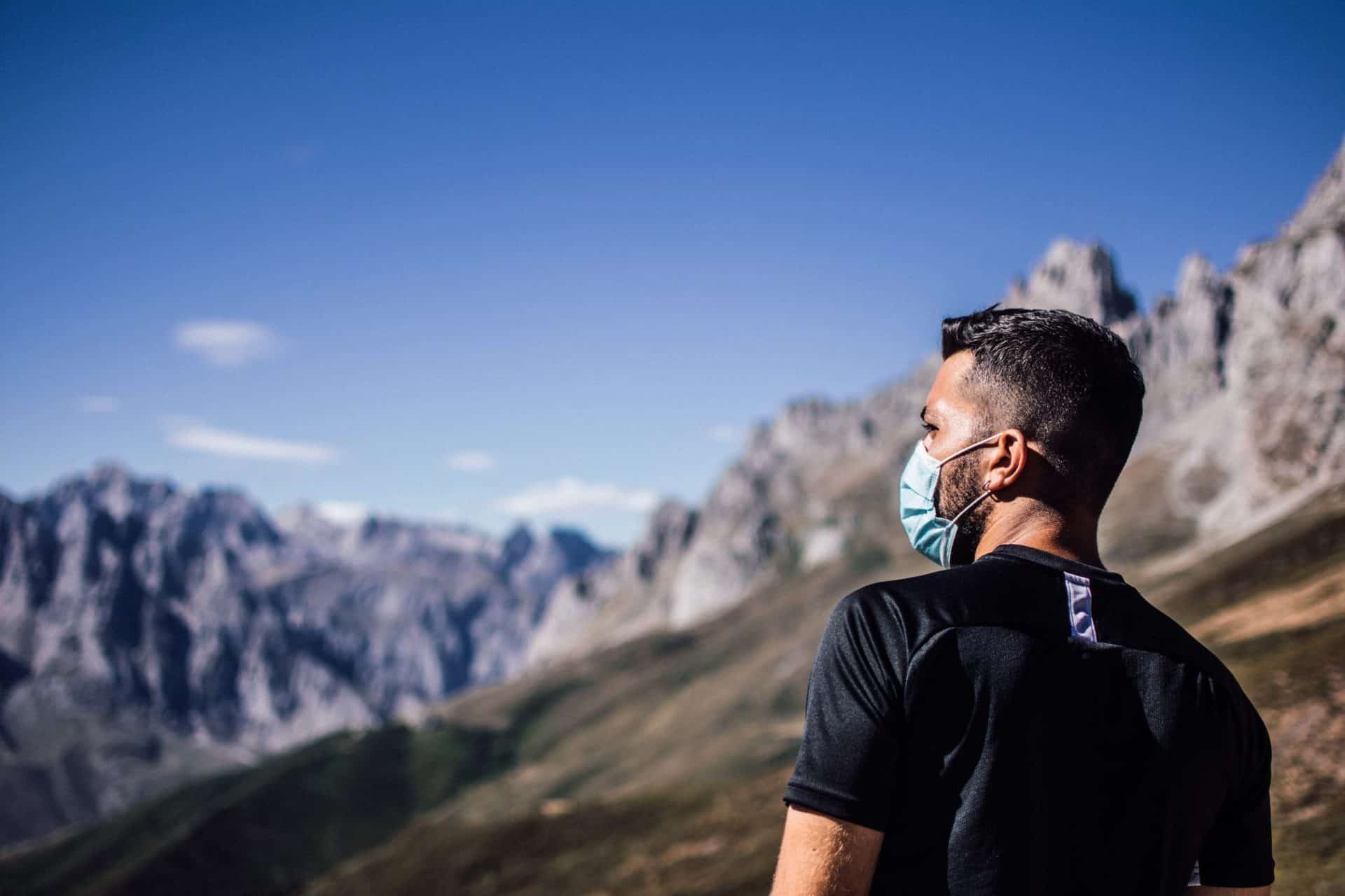 A man hiking with a face mask on