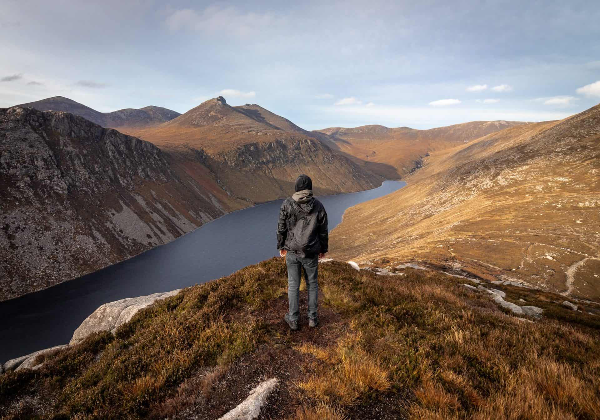 A man looking over a cliff in Northern Ireland