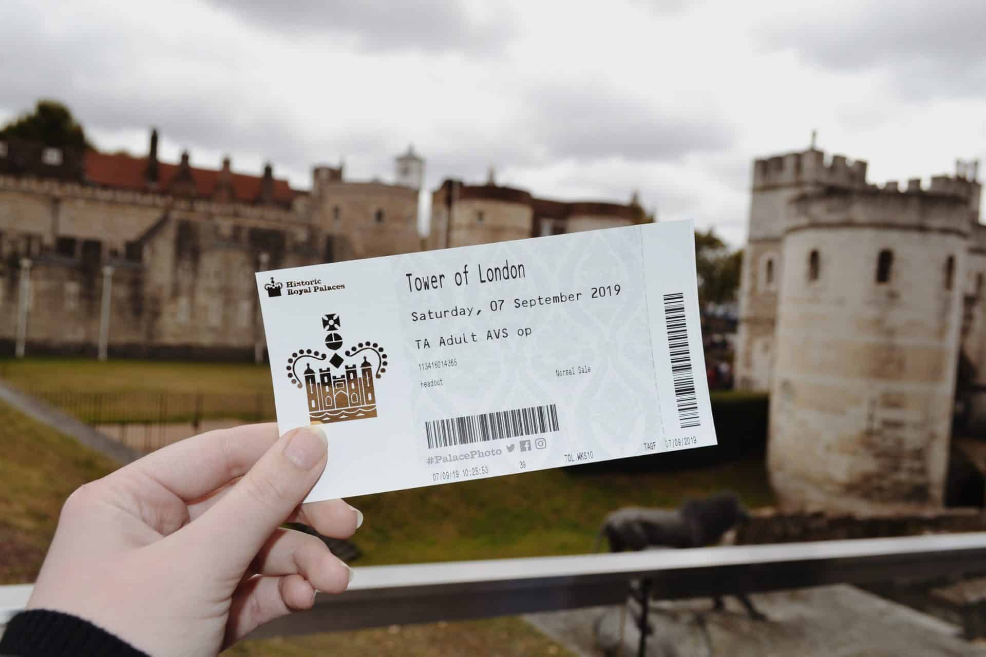A woman holding her entrance ticket to the Tower of London