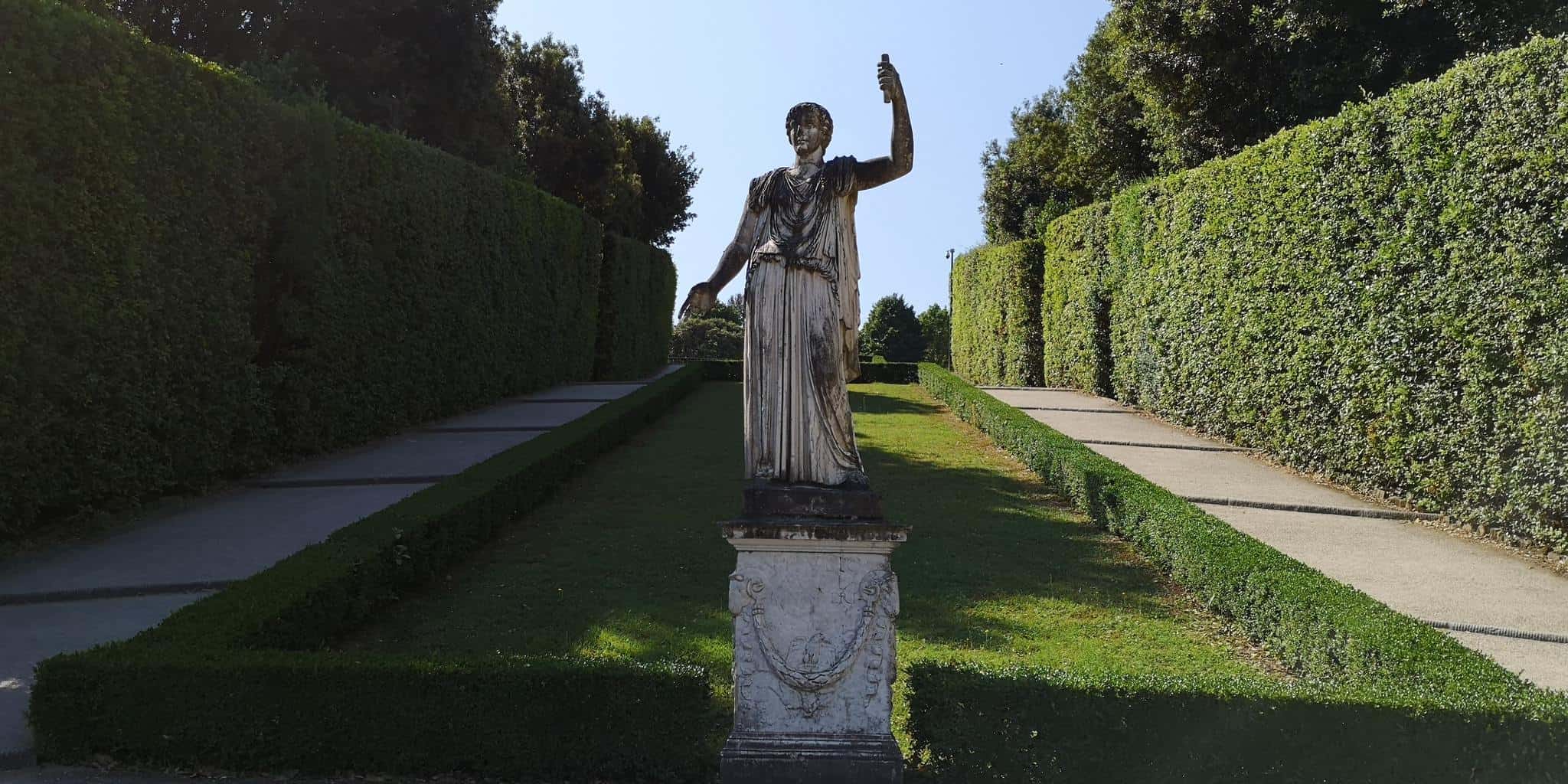 A statue stands hidden in the shade of the must-see garden bobble