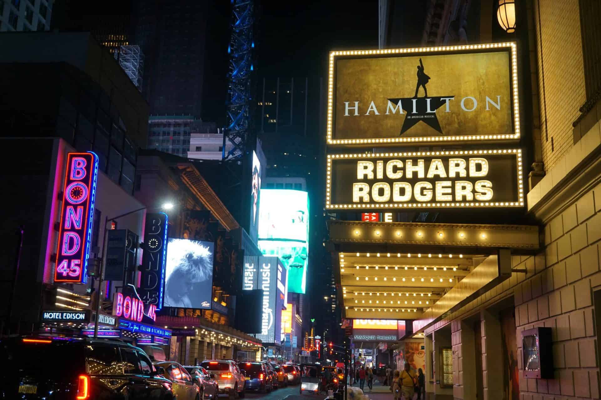 The Hamilton Marquee sign is lit on the streets of New York City