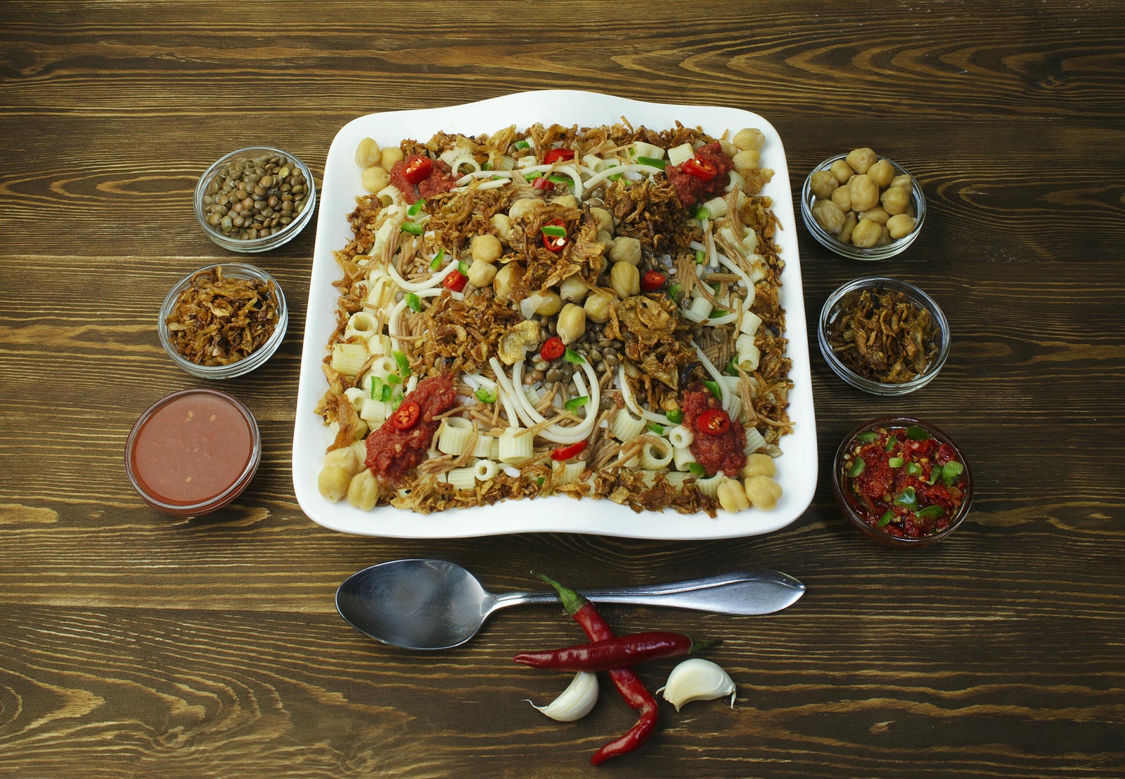 Koshari plate with extras on its sides.
