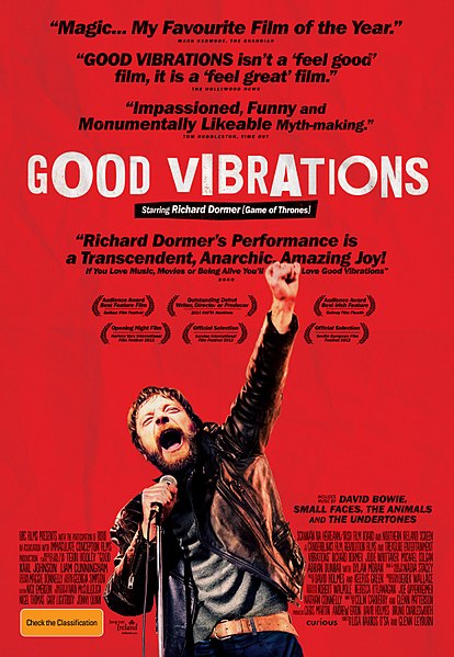 Movie poster for Good Vibrations, showing a bearded man passionately singing into a microphone. Set in Belfast, the red background features enthusiastic review quotes and the title in large white letters above the man.