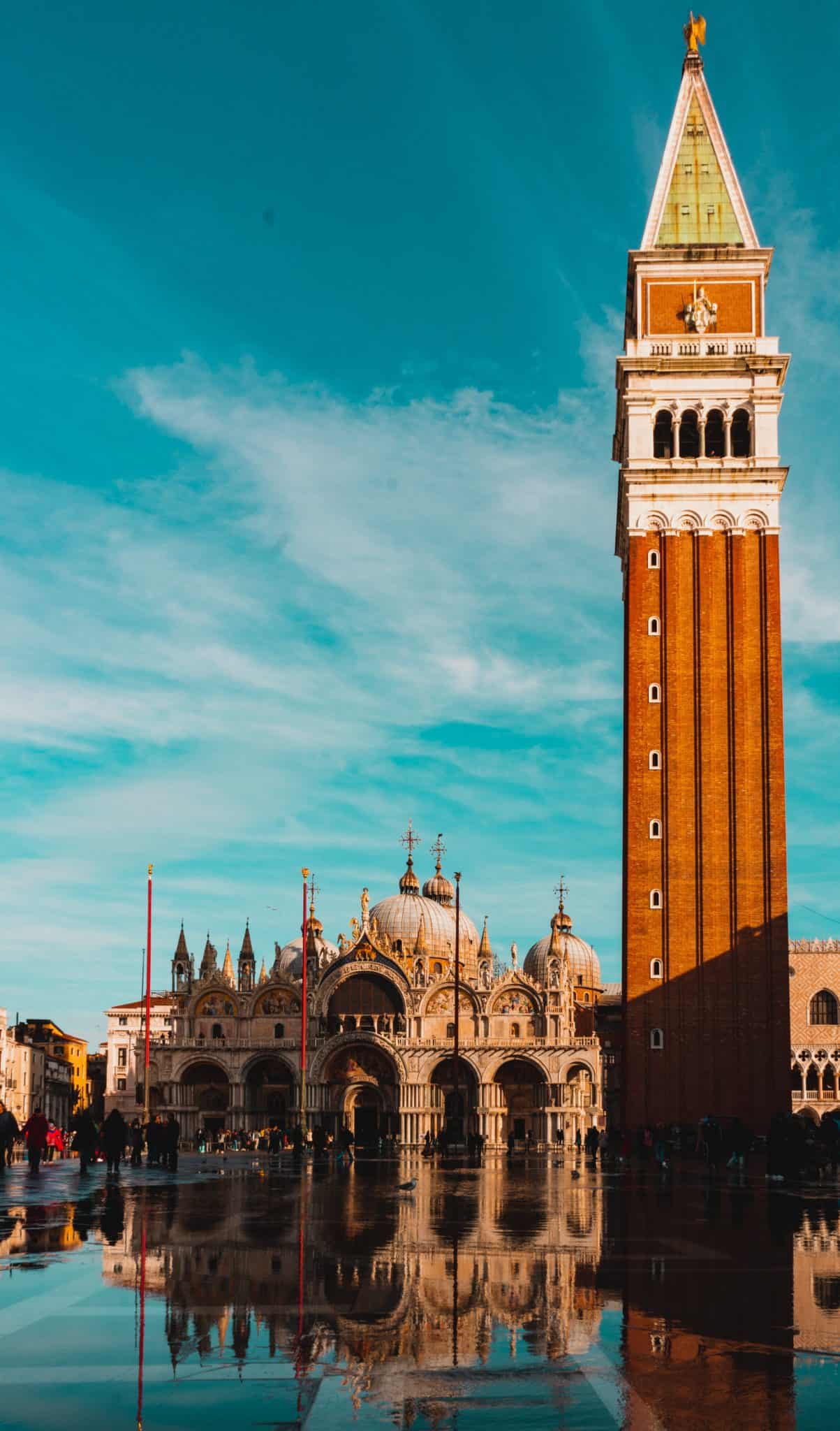 The tower of Piazza San Marco stands against the blue sky in Venice