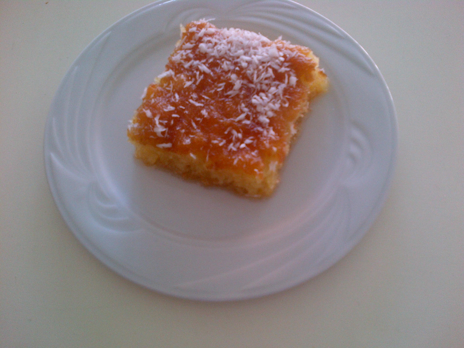 Basboosa on a plate sprinkled with coconut.