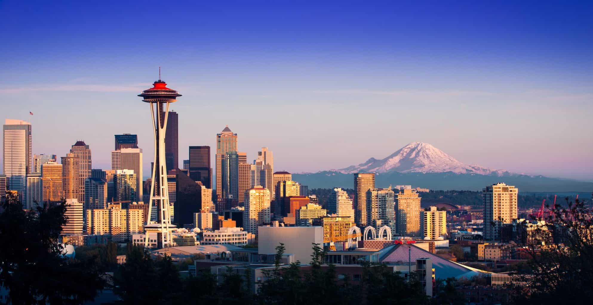 Aerial view of the skyline of Seattle with snowy mountain caps in the distance of the Pacific Northwest