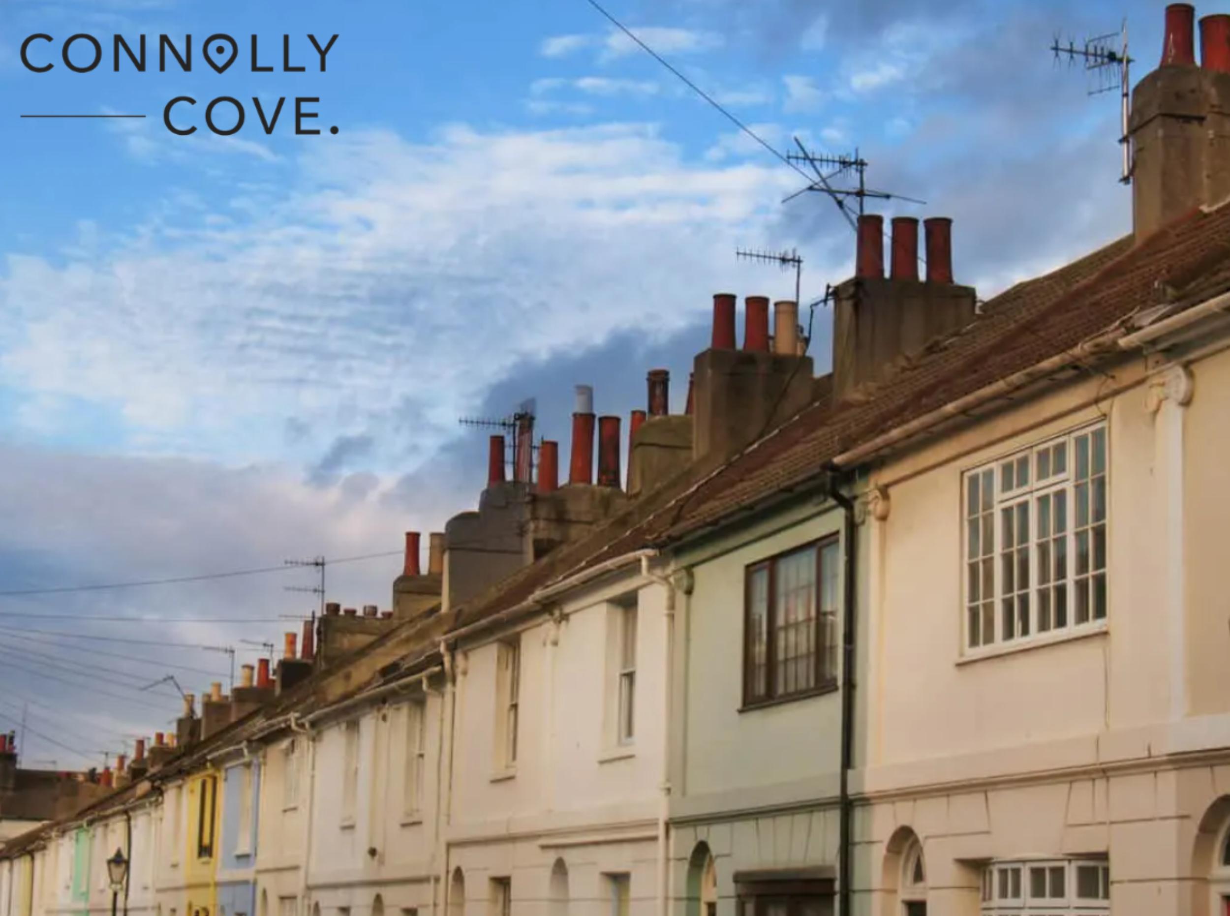 Old roofs and frontages under a cloudy blue sky in Brighton UK.