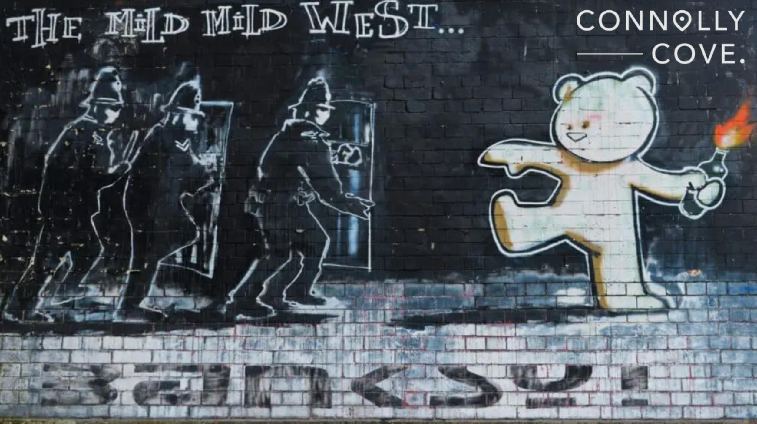 View of the famous Banksy graffiti piece titled Mild Mild West