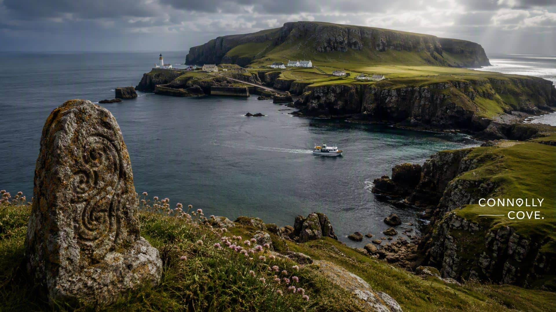 A scenic coastal view with a carved stone in the foreground, a boat on the water, cliffs, and a lighthouse can be seen alongside buildings dotted across grassy islands under a cloudy sky. This picturesque scene captures the tranquil beauty of Rathlin Island, a remote island off the coast. Text reads CONNOLLY COVE.
