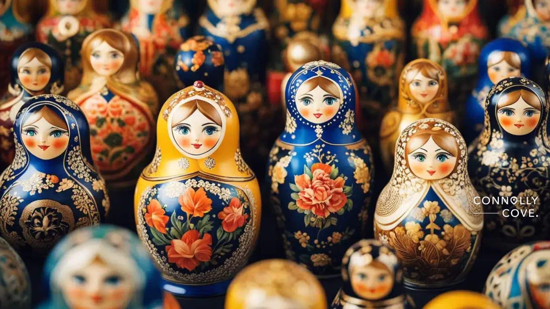 A collection of colourful Russian nesting dolls with intricate floral and traditional designs, arranged closely together. Showcasing the essence of Russian Folk Art, the dolls feature detailed, smiling faces and vibrant patterns.