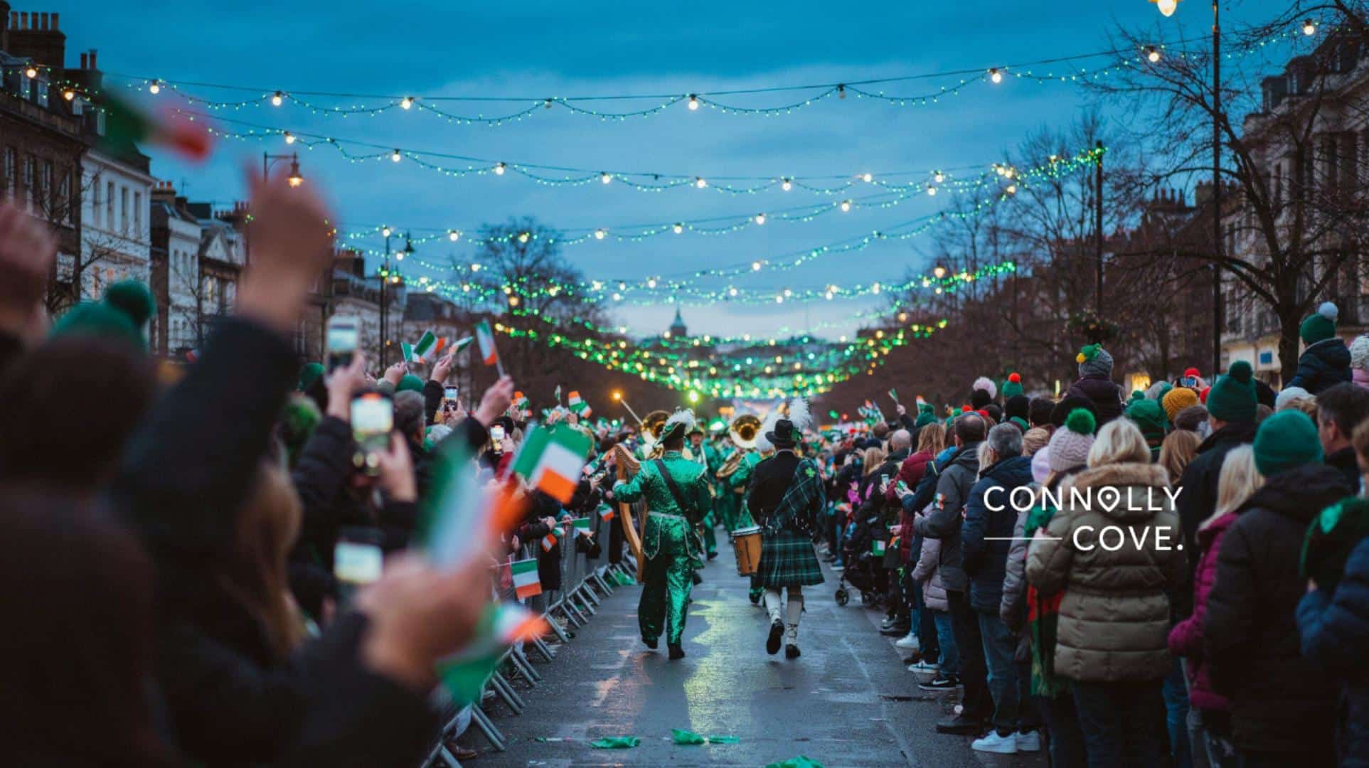 A festive St Patrick’s Day street parade with people waving Irish flags, wearing green hats and coats, as musicians in kilts march under fairy lights at dusk, capturing the lively spirit of Ireland.