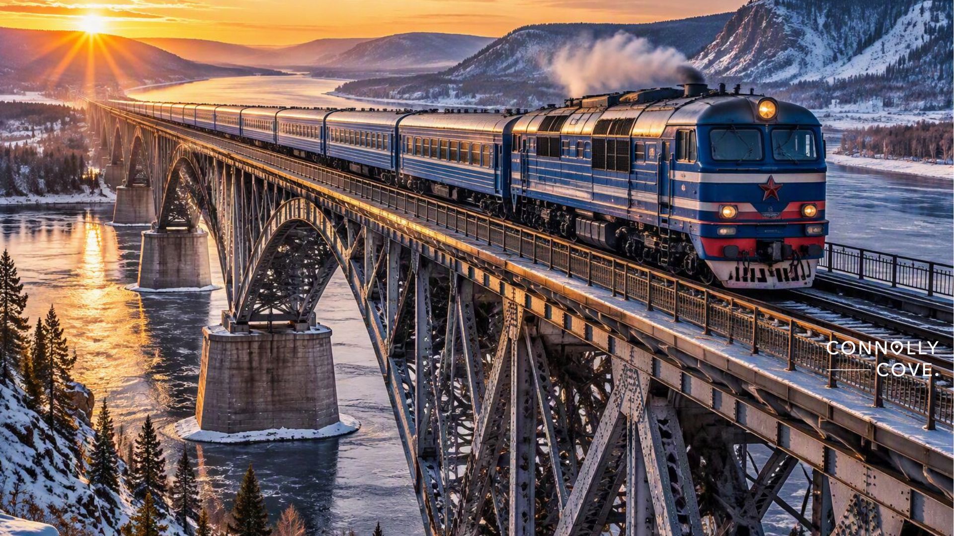 A blue train crosses a large steel bridge over a frozen river at sunset in Siberia, with snowy mountains behind. Steam rises from the Trans-Siberian Railway as golden sunlight illuminates the scene.